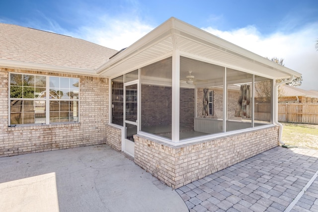 view of patio / terrace featuring a sunroom and fence
