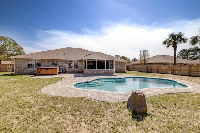 view of pool with a fenced backyard, a lawn, a patio area, and a hot tub
