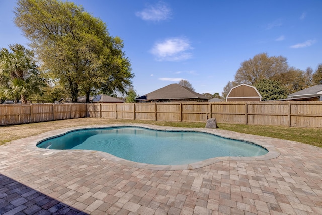 view of swimming pool featuring a fenced backyard, a fenced in pool, and a patio