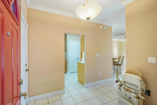entryway featuring light tile patterned floors, baseboards, and ornamental molding