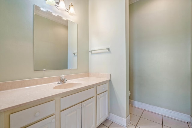 bathroom with tile patterned flooring, vanity, and baseboards