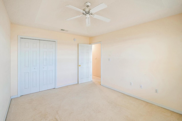 unfurnished bedroom featuring a closet, visible vents, baseboards, and carpet floors