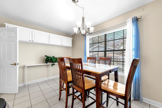dining space featuring baseboards, a notable chandelier, light tile patterned floors, and a healthy amount of sunlight