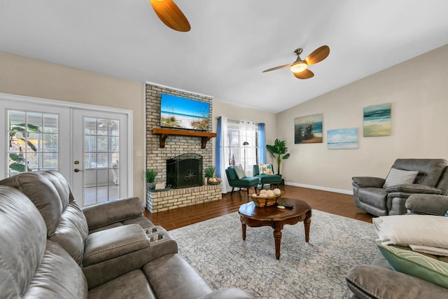 living area featuring plenty of natural light, vaulted ceiling, wood finished floors, and a ceiling fan