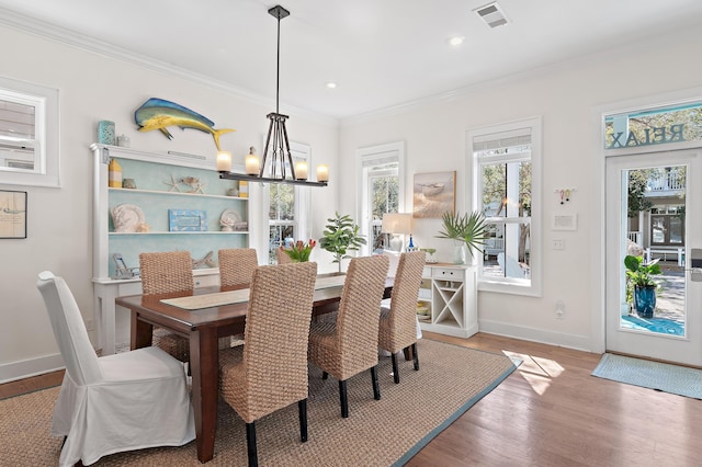68 N Ryan St, Santa Rosa Beach, FL 32459 - dining space featuring wood finished floors, ornamental molding, a chandelier, and visible vents