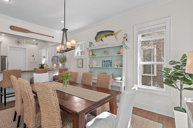 68 N Ryan St, Santa Rosa Beach, FL 32459 - dining area featuring a wealth of natural light, crown molding, wood finished floors, and baseboards