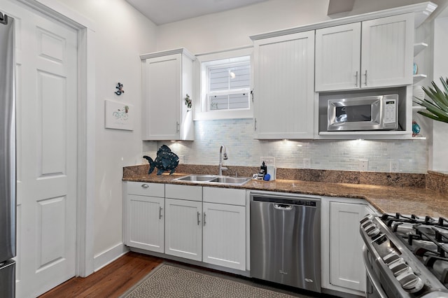 68 N Ryan St, Santa Rosa Beach, FL 32459 - kitchen with backsplash, a sink, white cabinetry, stainless steel appliances, and dark wood-style flooring