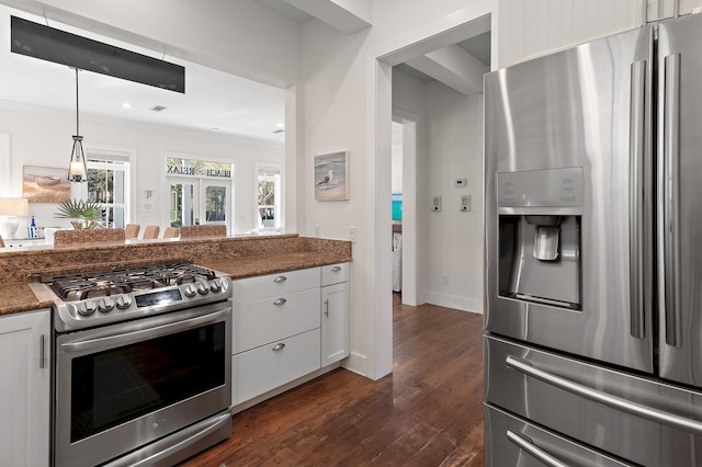 68 N Ryan St, Santa Rosa Beach, FL 32459 - kitchen featuring dark wood-style flooring, white cabinets, stainless steel appliances, dark stone countertops, and hanging light fixtures