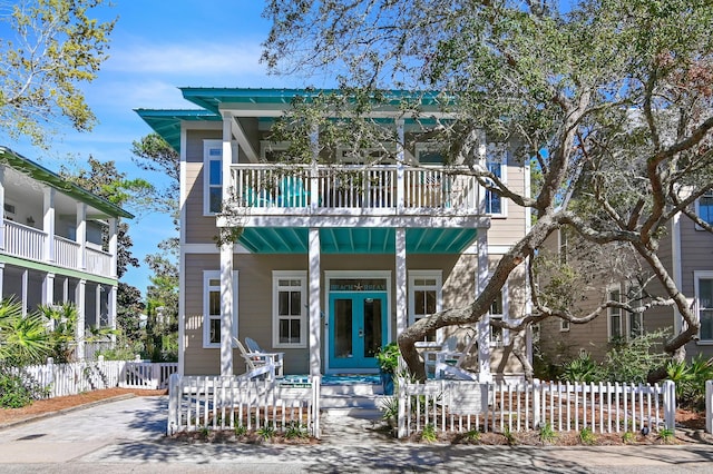 68 N Ryan St, Santa Rosa Beach, FL 32459 - view of front of home with french doors, a balcony, a porch, and fence