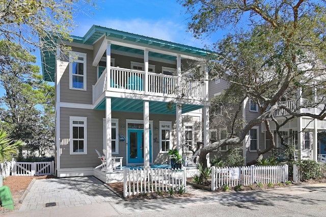 68 N Ryan St, Santa Rosa Beach, FL 32459 - view of front of house featuring a balcony, fence, and a porch