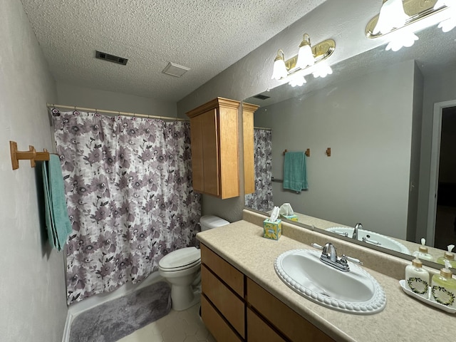 bathroom featuring a textured ceiling, visible vents, toilet, and vanity
