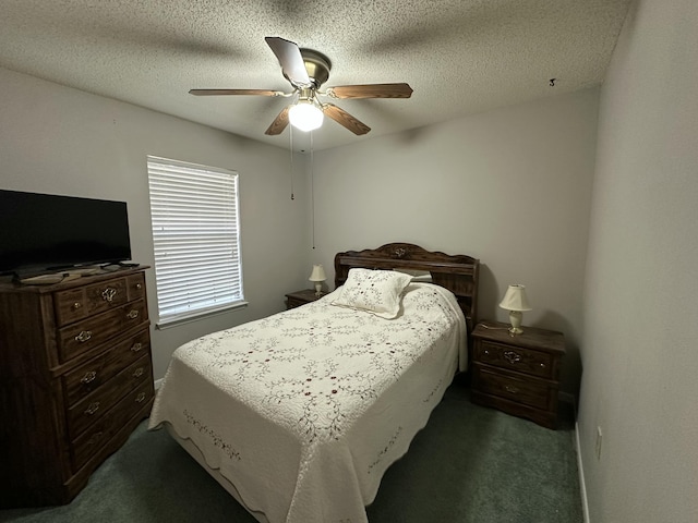 bedroom with a ceiling fan, carpet floors, and a textured ceiling