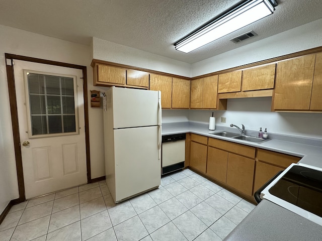 kitchen with visible vents, a sink, brown cabinets, and white appliances