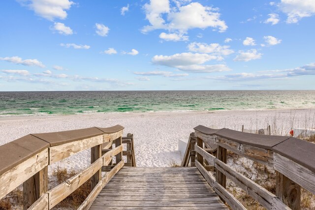 view of community featuring a beach view and a water view