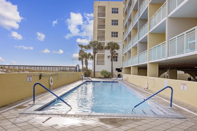 community pool with a patio area