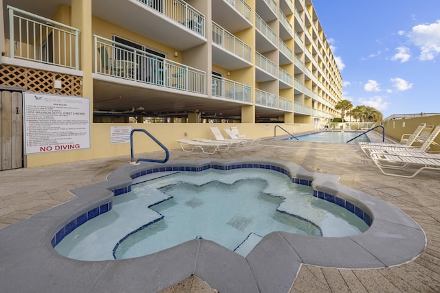 pool featuring a patio and a hot tub
