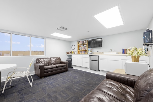 living room featuring dark carpet and visible vents