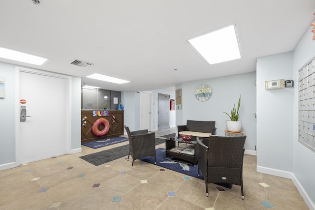 office space with baseboards and visible vents
