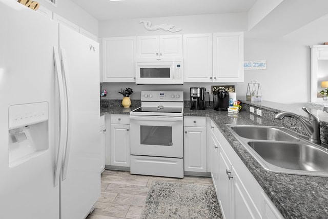 kitchen featuring white cabinets, a sink, and white appliances