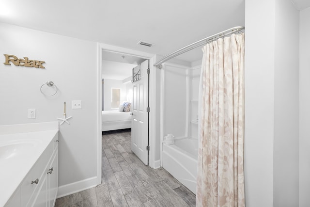 full bath with vanity, baseboards, visible vents, shower / bath combo with shower curtain, and wood finished floors