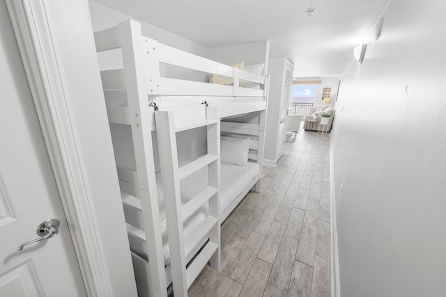 hall featuring baseboards and wood finish floors