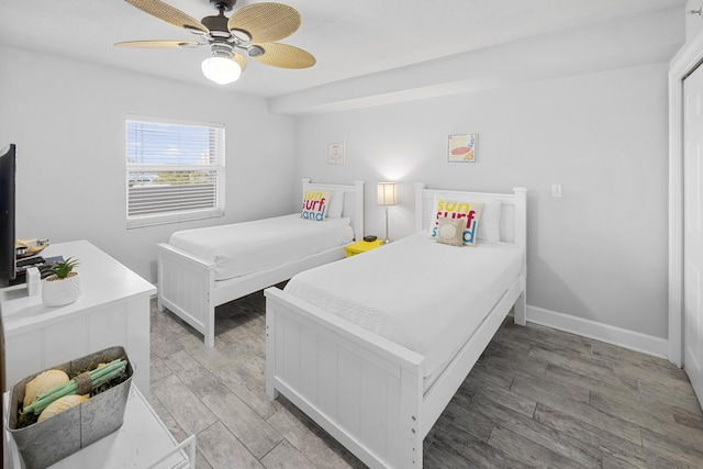 bedroom featuring baseboards, light wood-style floors, and ceiling fan