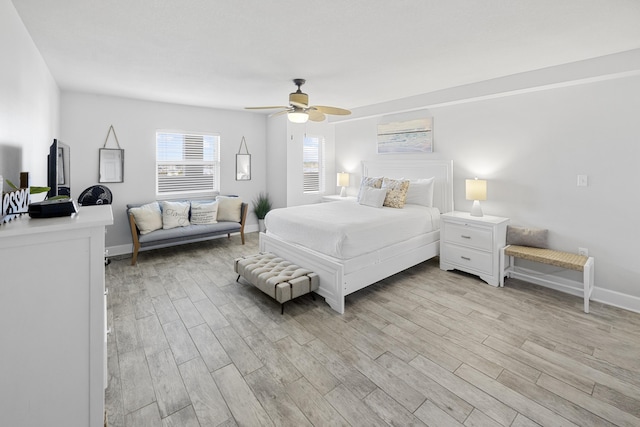 bedroom with baseboards, light wood-style floors, and ceiling fan