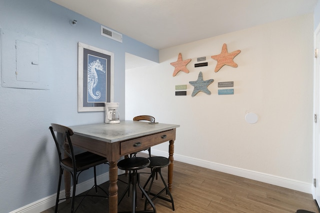 790 Santa Rosa Blvd Unit 403, Fort Walton Beach, FL 32548 - dining room featuring wood finished floors, visible vents, baseboards, and electric panel