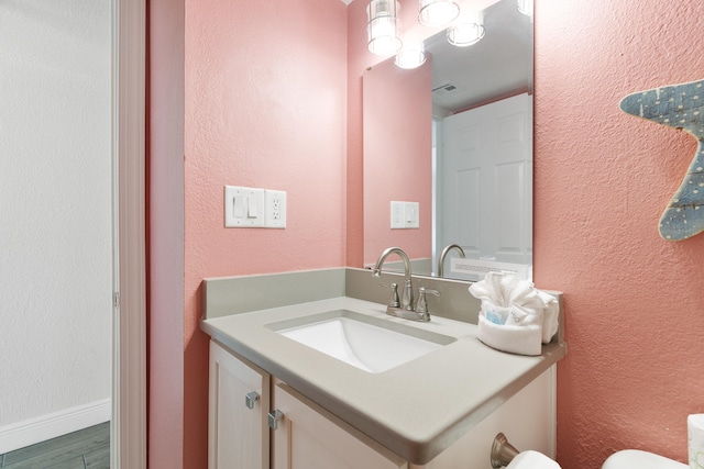 790 Santa Rosa Blvd Unit 403, Fort Walton Beach, FL 32548 - bathroom with vanity, toilet, a textured wall, visible vents, and wood finished floors