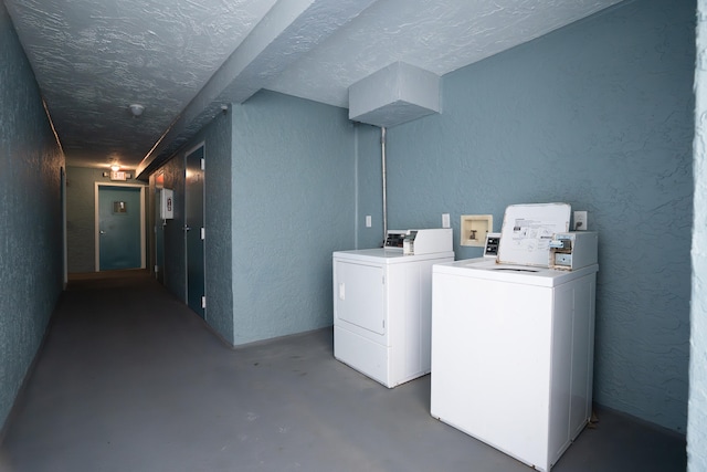 790 Santa Rosa Blvd Unit 403, Fort Walton Beach, FL 32548 - common laundry area with a textured ceiling, a textured wall, and washer and clothes dryer