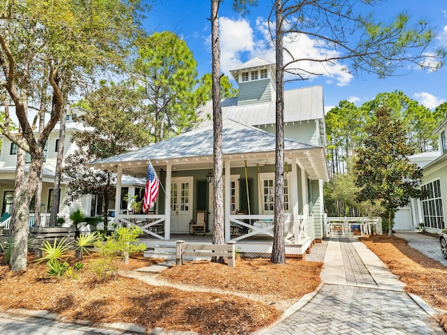view of front of home with a porch and metal roof