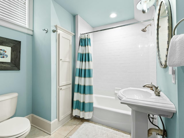 bathroom featuring shower / tub combo, toilet, tile patterned flooring, and baseboards