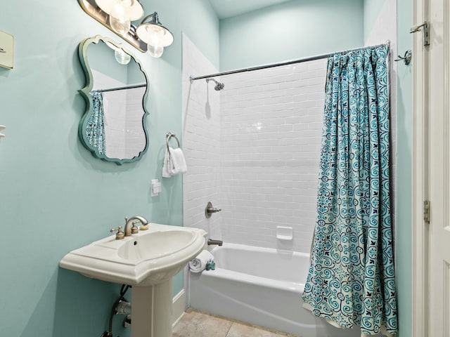full bath with shower / bath combo and tile patterned floors