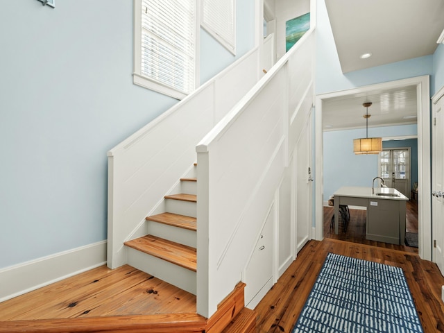 stairs with baseboards and hardwood / wood-style flooring
