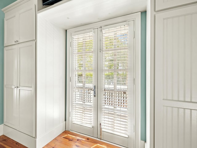 doorway to outside with french doors and light wood-type flooring