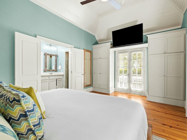 bedroom featuring light wood-style floors, connected bathroom, a ceiling fan, access to exterior, and lofted ceiling