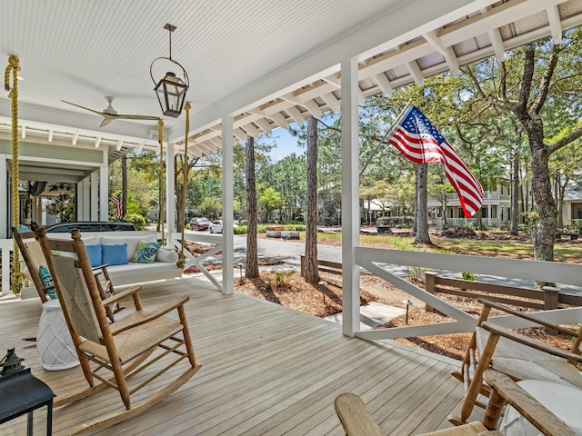 wooden deck featuring ceiling fan