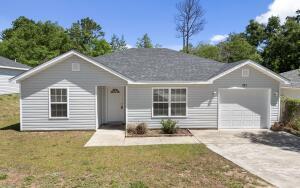 321 Apple Dr, Crestview, FL 32536 - ranch-style house featuring a garage, driveway, and a front yard