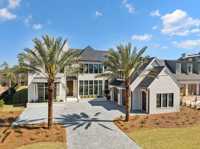 342 Windsong Dr, Inlet Beach, FL 32461 - view of front of house with decorative driveway, fence, stucco siding, and a garage