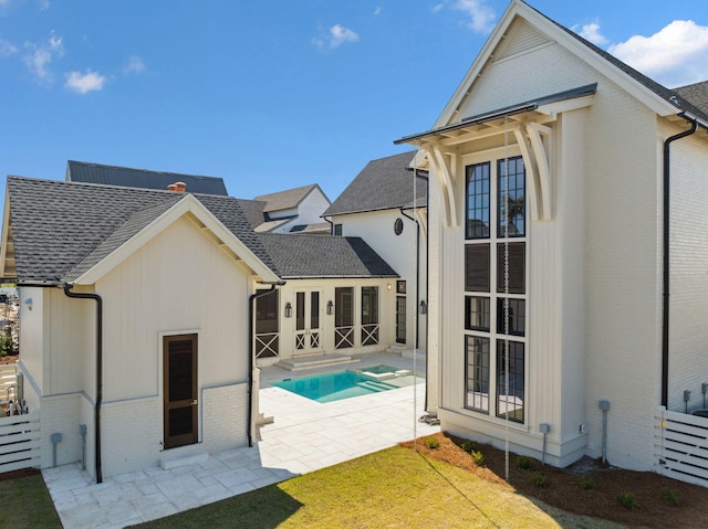 342 Windsong Dr, Inlet Beach, FL 32461 - rear view of house with an outdoor pool, roof with shingles, fence, a patio, and brick siding