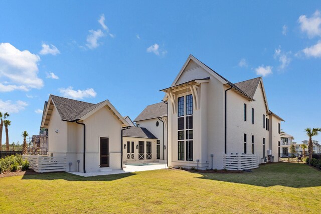 342 Windsong Dr, Inlet Beach, FL 32461 - back of house with a lawn, brick siding, fence, and a patio area