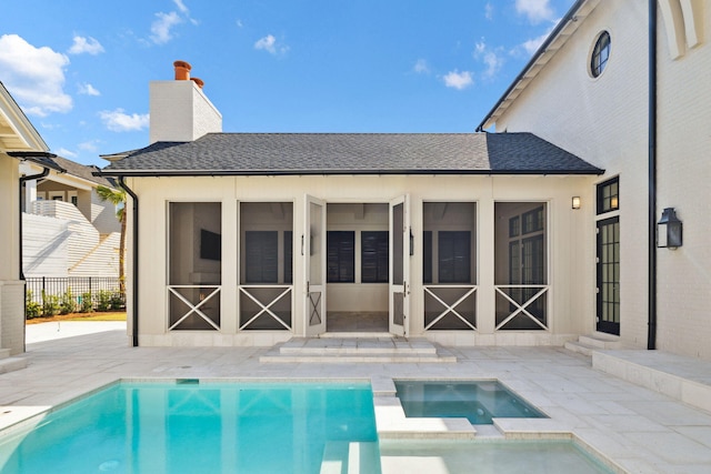 342 Windsong Dr, Inlet Beach, FL 32461 - rear view of house featuring a chimney, a sunroom, a shingled roof, and a patio area
