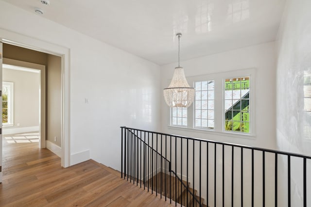 342 Windsong Dr, Inlet Beach, FL 32461 - corridor with plenty of natural light, an upstairs landing, a chandelier, and wood finished floors