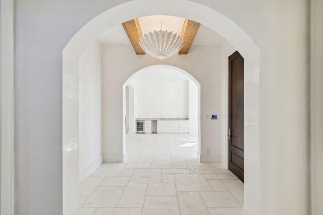 342 Windsong Dr, Inlet Beach, FL 32461 - hall featuring baseboards, an inviting chandelier, and stone tile floors