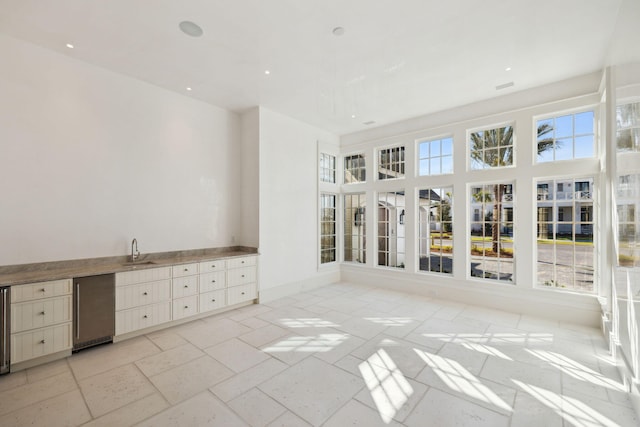 342 Windsong Dr, Inlet Beach, FL 32461 - unfurnished sunroom featuring wine cooler, a sink, and a healthy amount of sunlight
