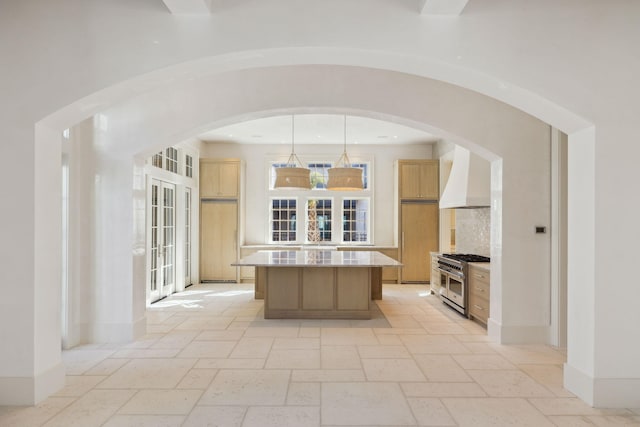342 Windsong Dr, Inlet Beach, FL 32461 - kitchen featuring light countertops, custom range hood, a center island, range with two ovens, and stone tile flooring