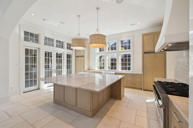 342 Windsong Dr, Inlet Beach, FL 32461 - kitchen with french doors, light brown cabinetry, high end stainless steel range oven, stone tile flooring, and custom exhaust hood
