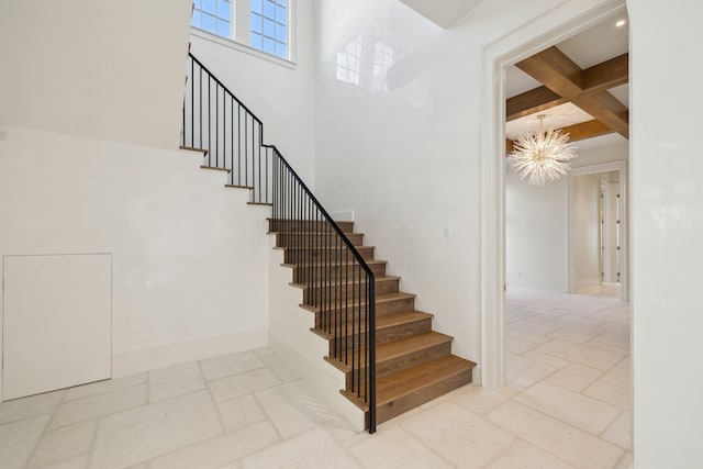 342 Windsong Dr, Inlet Beach, FL 32461 - staircase featuring coffered ceiling, a notable chandelier, beam ceiling, stone tile flooring, and baseboards