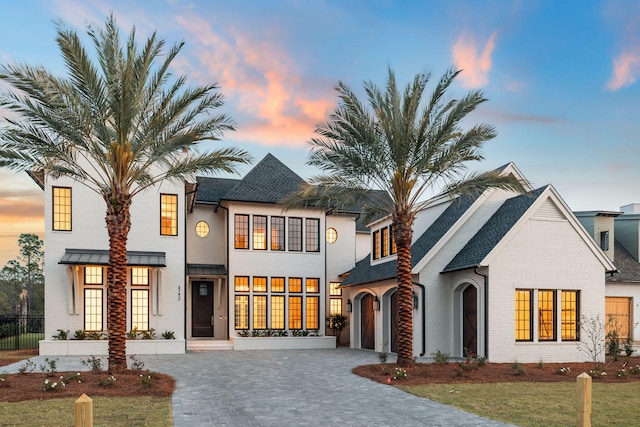 342 Windsong Dr, Inlet Beach, FL 32461 - view of front of house with fence, decorative driveway, brick siding, a garage, and a shingled roof