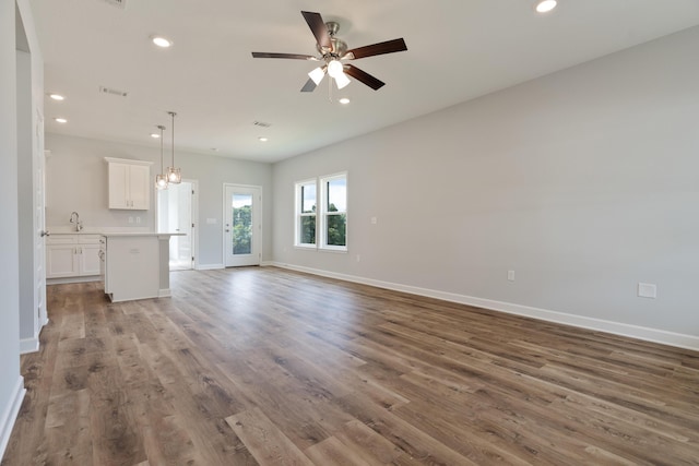 6119 Tansey St, Crestview, FL 32539 - unfurnished living room with ceiling fan, wood finished floors, baseboards, and recessed lighting